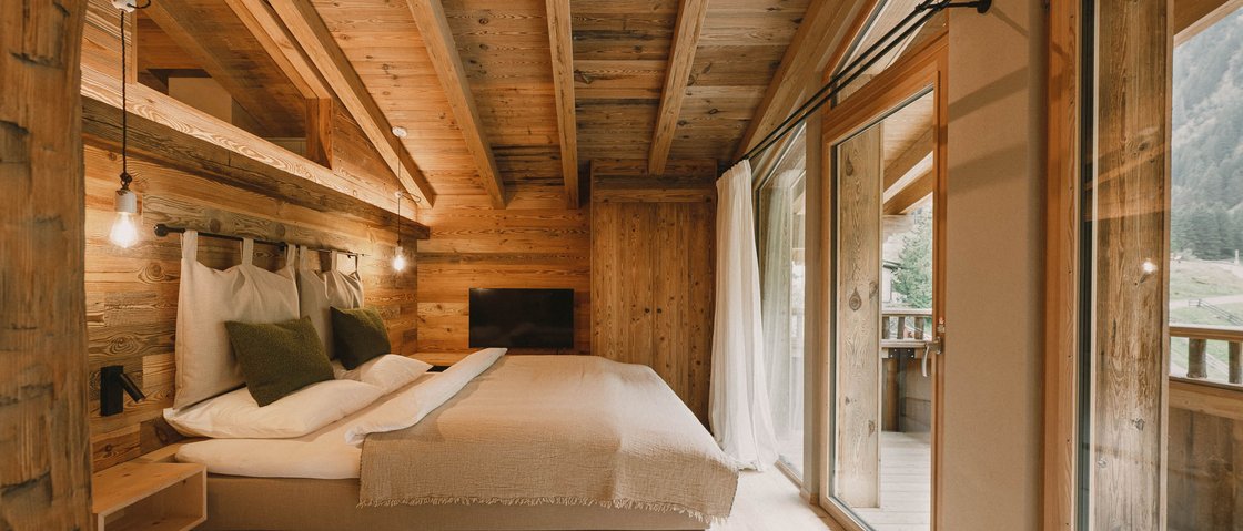 Get away from it all and relax at our chalet in Stubaital Cozy bedroom in a wooden cabin with large bed and balcony