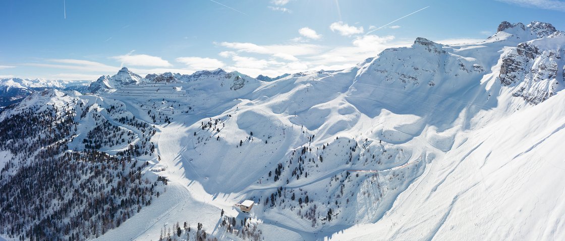 Your unforgettable ski holiday in Stubaital Sunny winter day in snow-covered mountains with ski trails and blue sky
