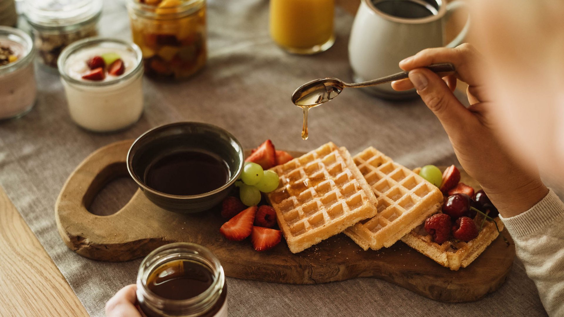 Culinary indulgence all across Stubaital Waffles with fresh fruit and honey served on wooden board